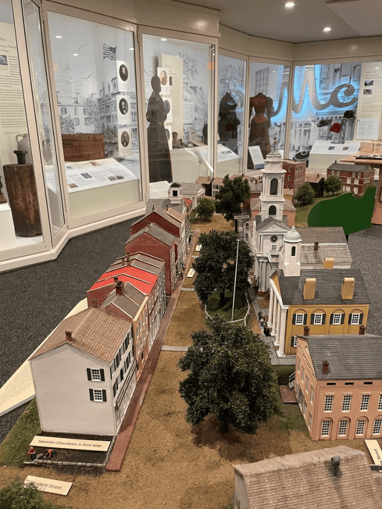 Miniature historic town model with buildings and trees showcasing American architecture history.
