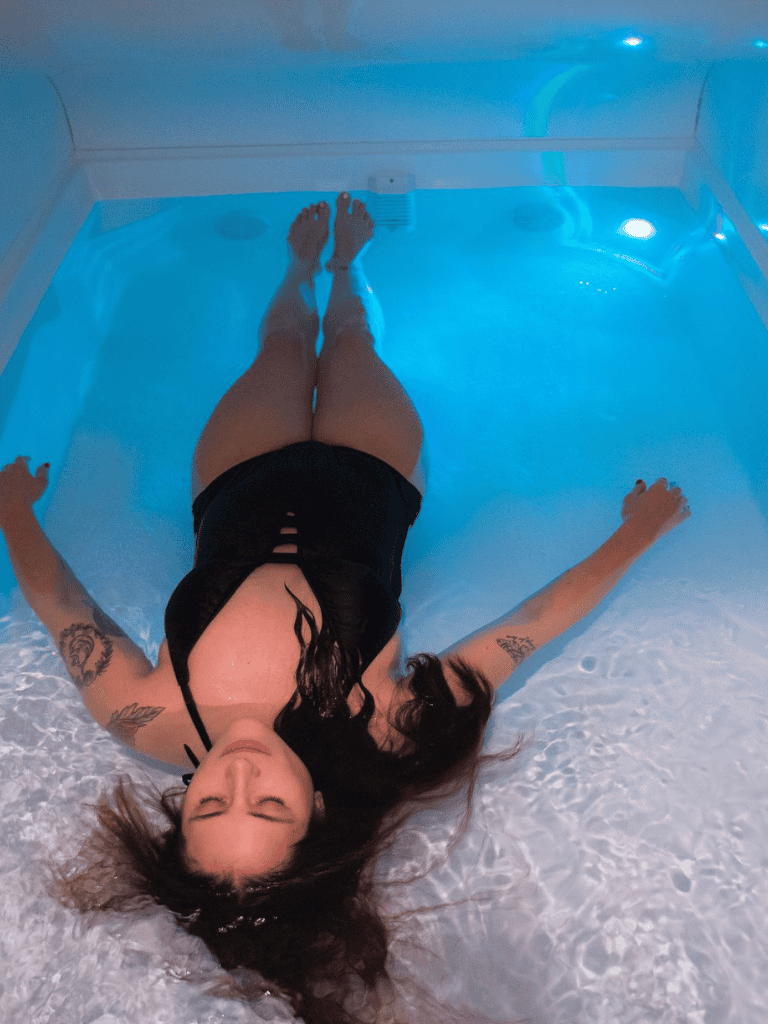 Relaxing in a float therapy session in a modern wellness center.
