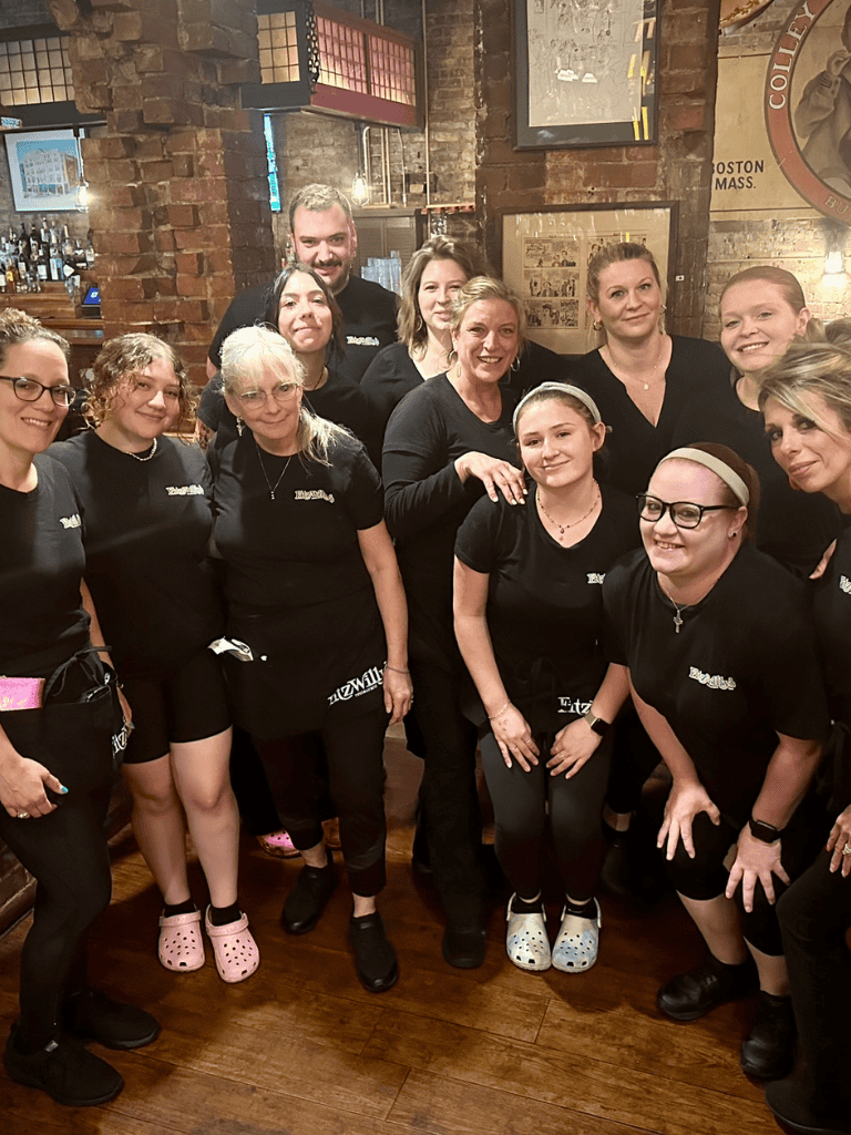 Cleaning team group photo at QuestForDirections restaurant in Boston, MA, showcasing hospitality staff collaboration.