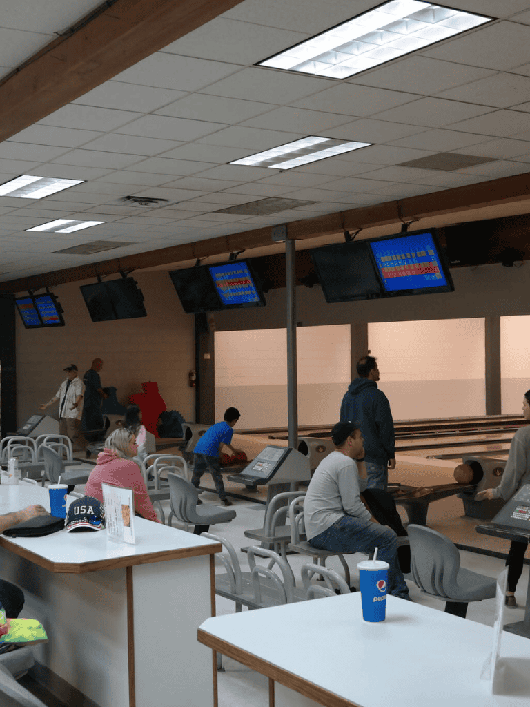 Boardwalk bowling alley with electronic scoring and seating area.