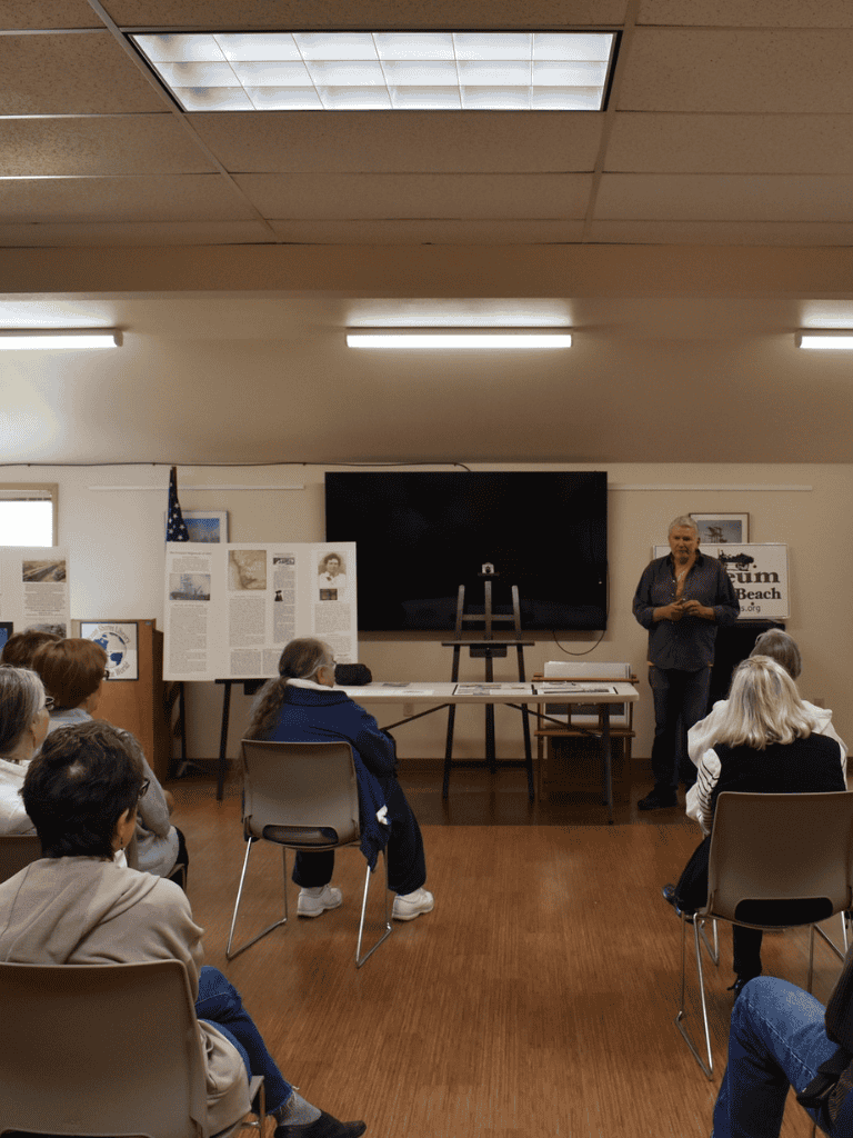 1. Indoor community workshop with presenter and audience at QuestForDirections.
