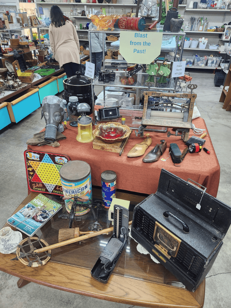 Vintage collectibles and antiques displayed at QuestForDirections thrift store.