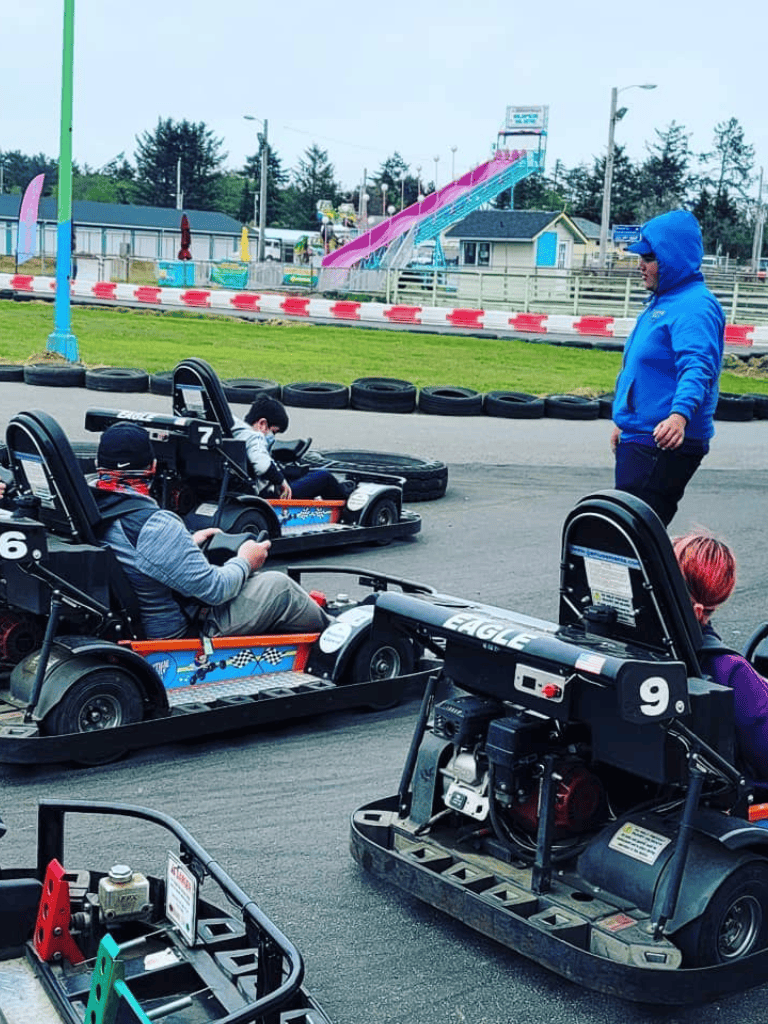 Go-kart race track at QuestForDirections amusement park on a cloudy day.