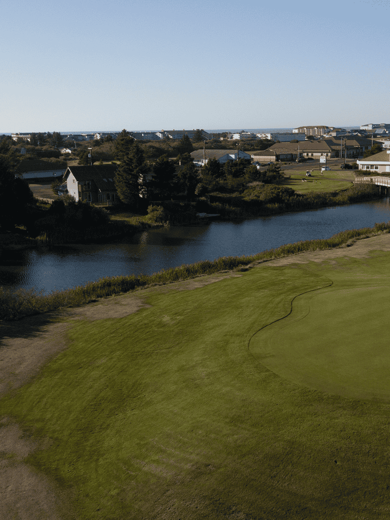 Beautiful coastal golf course with water hazards and scenic neighborhood views.