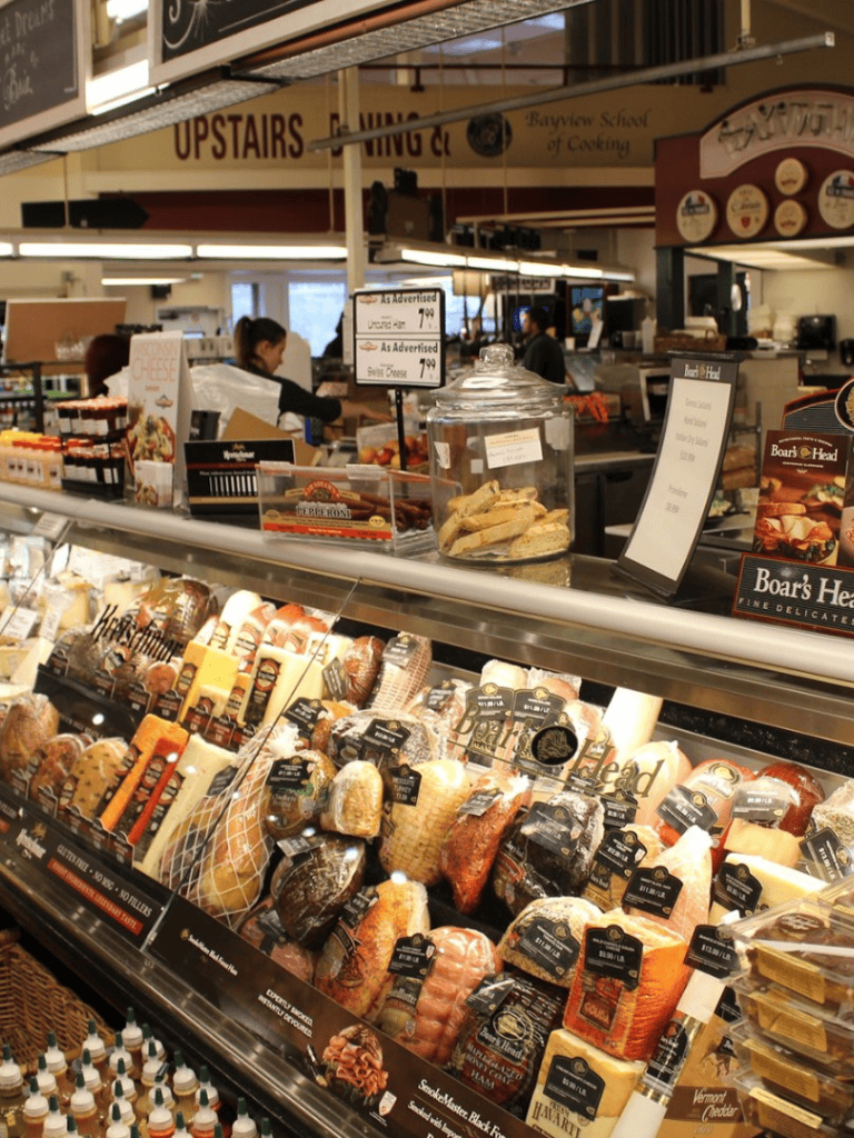 High-quality cheese display at QuestForDirections grocery store, showcasing a variety of artisanal cheeses.