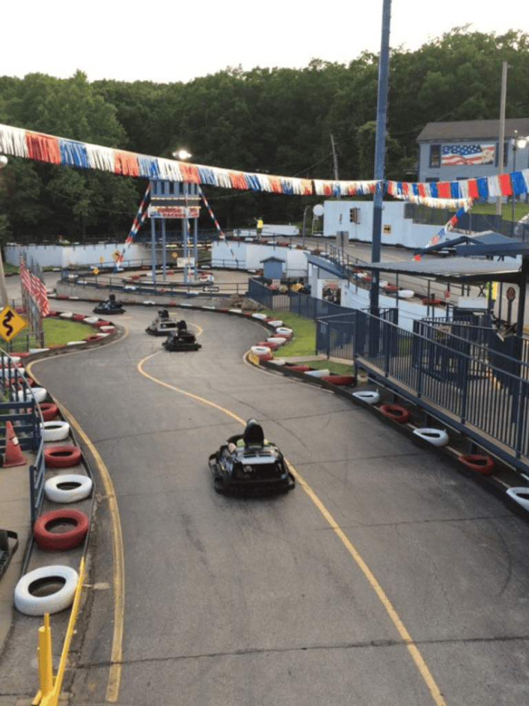 Racing go-karts at Quest for Directions amusement park during daytime.