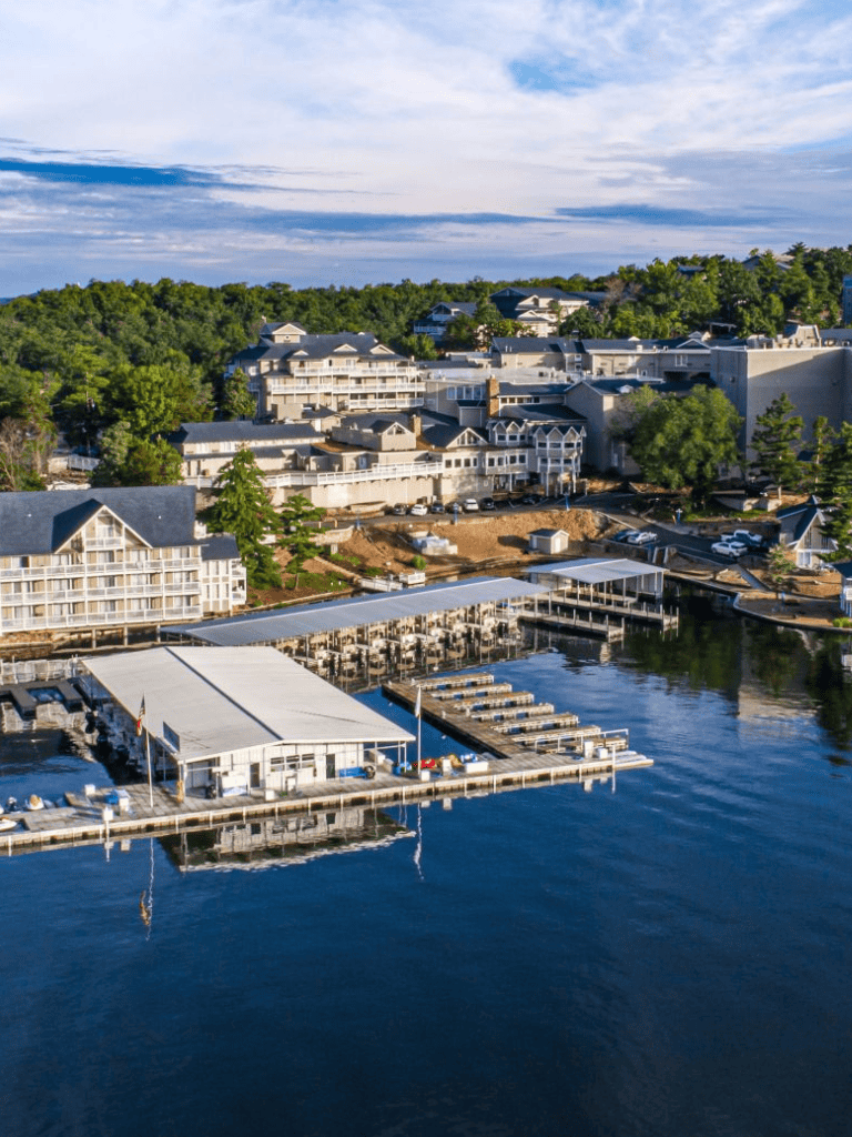 Luxurious lakeside resort with marina and scenic hillside views, perfect for vacation and relaxation.