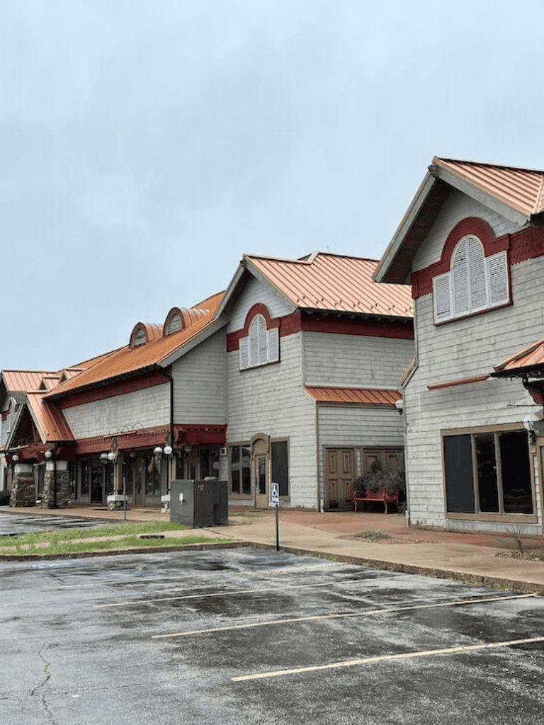 Luxury shopping mall with boutique stores and restaurants, modern architecture, sunny outdoor area, ideal for leisure and retail therapy.