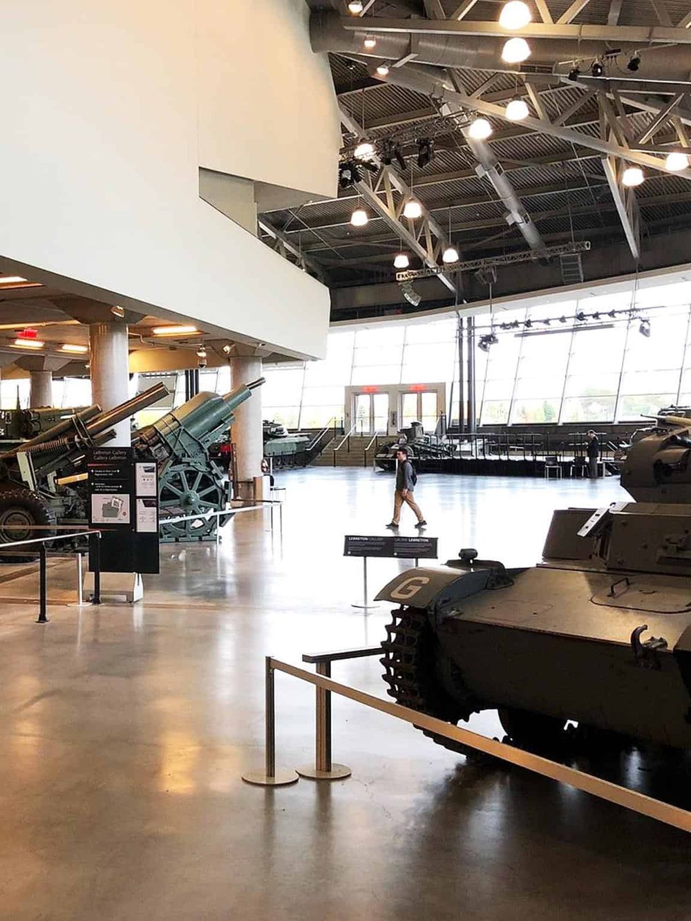 Modern military museum display with tanks and artillery pieces.