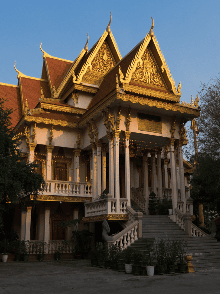 Intricate Thai temple with ornate golden details and traditional architecture.