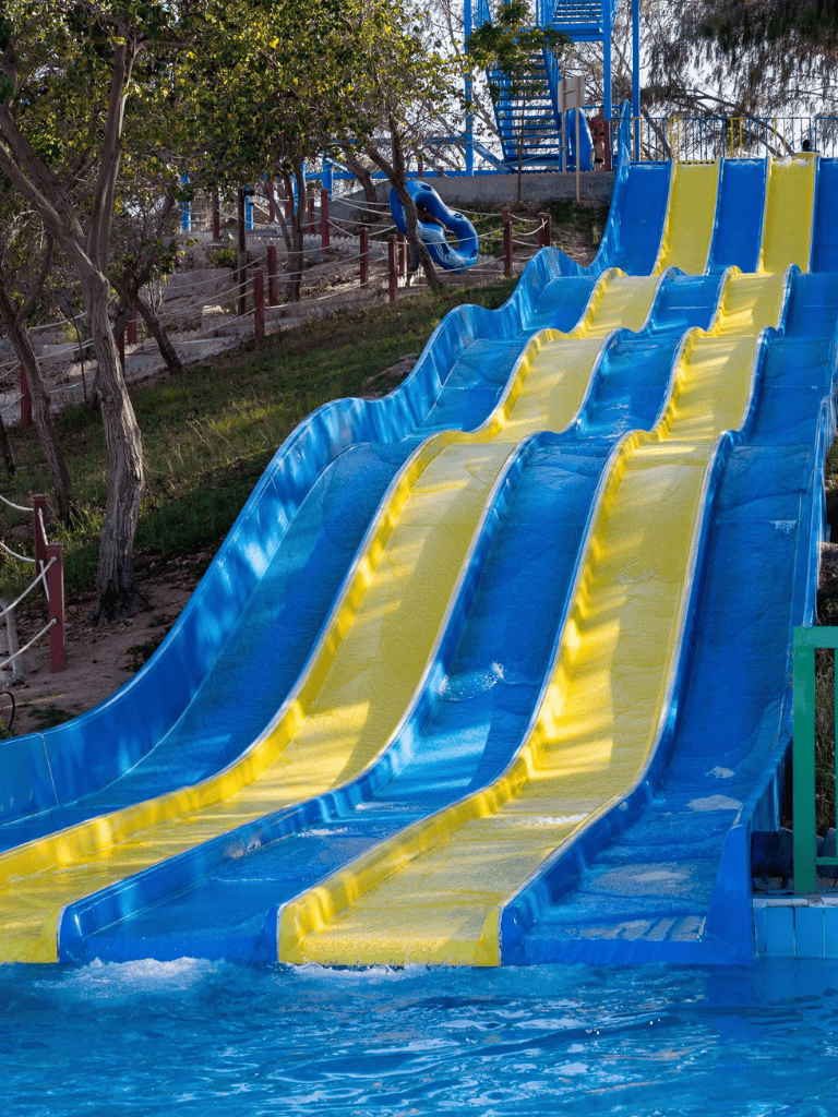 Colorful water slides at QuestForDirections amusement park, family-friendly outdoor water attraction.