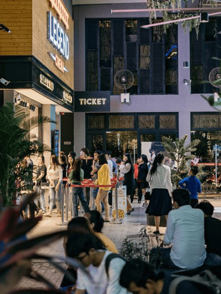 Waiting in line for movie tickets at QuestForDirections theater.