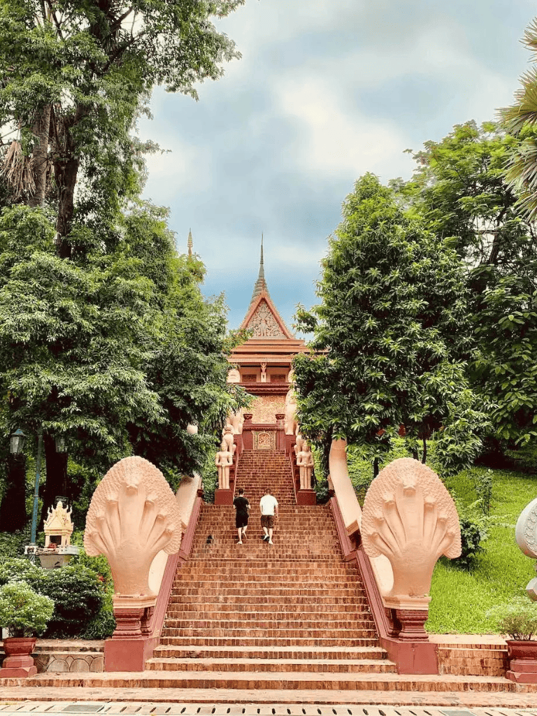 Ancient temple stairs surrounded by lush greenery in Thailand.