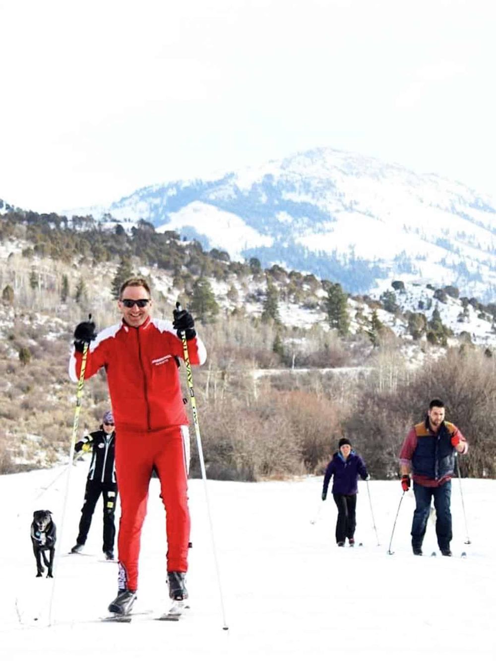 1. Cross-country skiing adventure in snowy mountain landscape with group of skiers.
