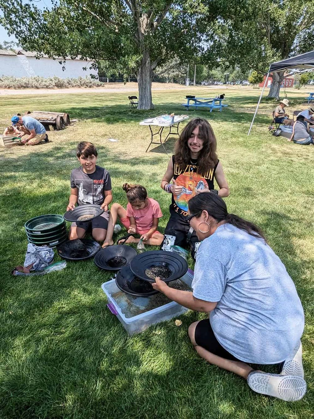 Kids exploring and learning at a community outdoor event organized by Quest For Directions.