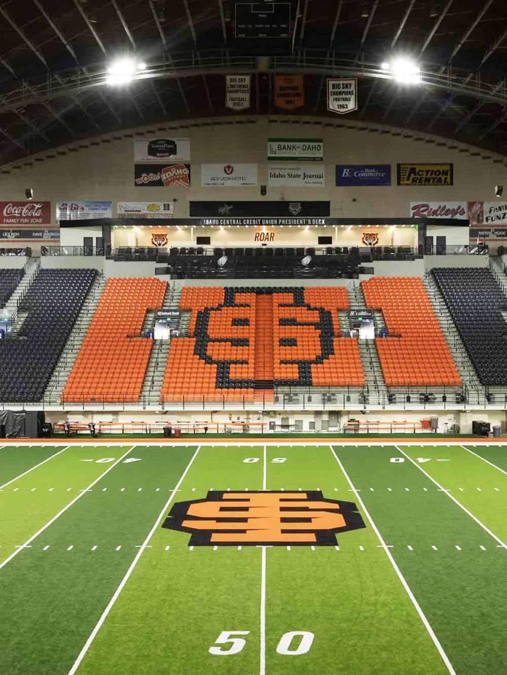 1. Interior view of Boise State Broncos football stadium with orange and black seating and field.