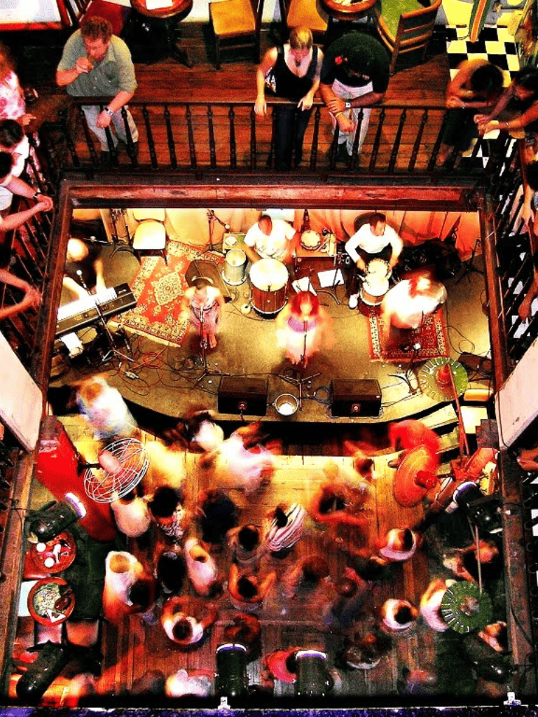 Live band performance at a lively restaurant or bar with indoor and outdoor seating for social gatherings.