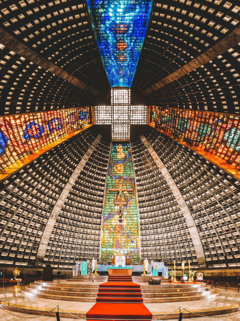 Colorful church interior with stained glass windows and altar, showcasing religious architecture and spiritual ambiance.
