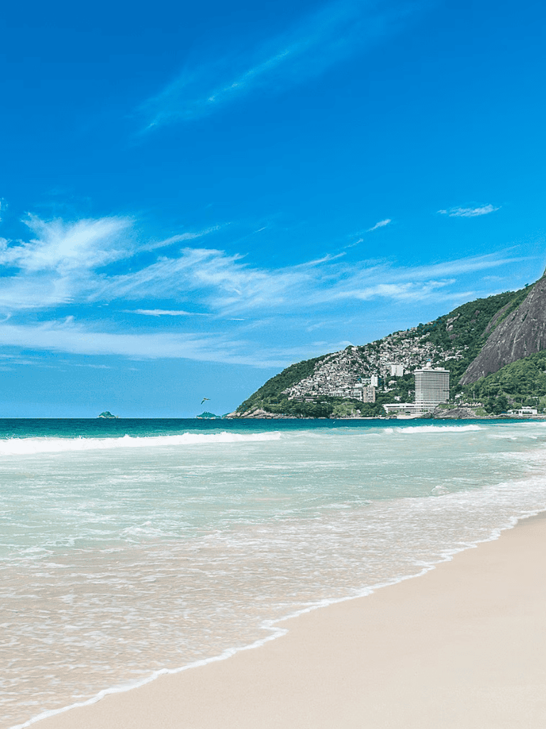 Relaxing beach with turquoise waters and scenic mountain view for travel and vacation planning, QuestForDirections SEO image.