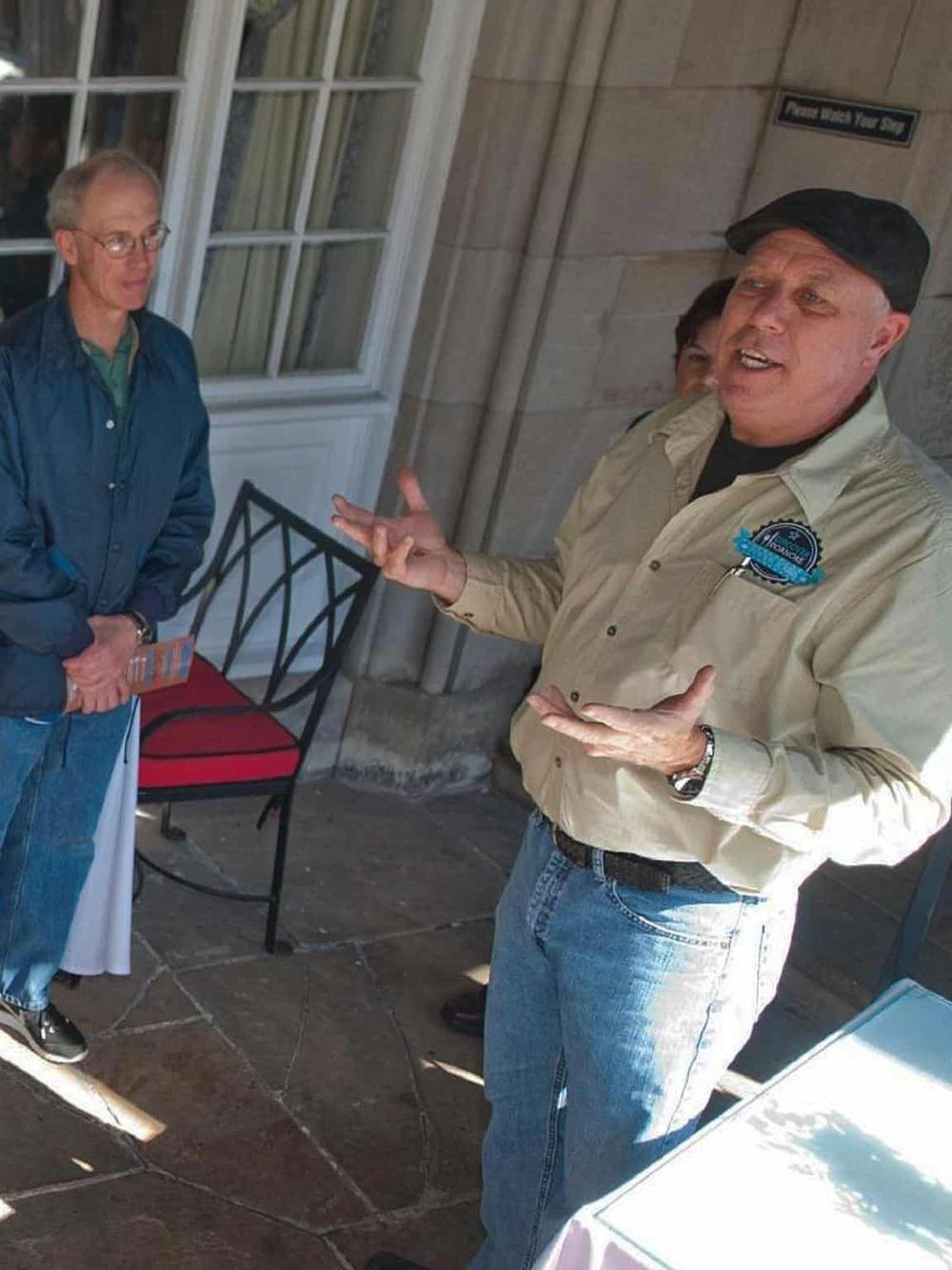 Engaging outdoor guide sharing directions with visitors at QuestForDirections.