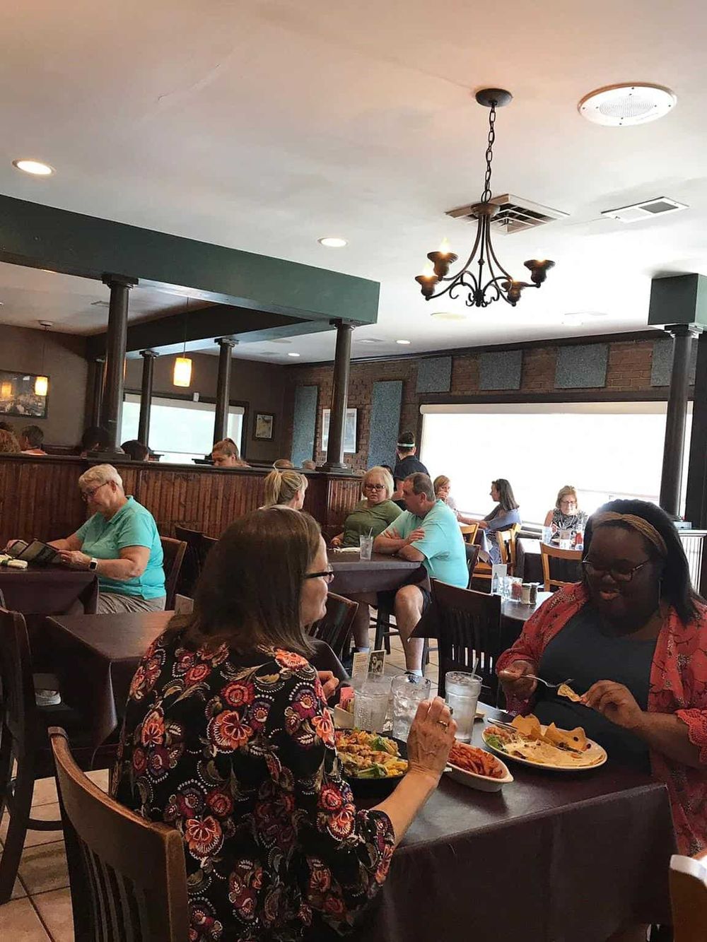 Warm interior dining at Quest for Directions restaurant with diverse guests enjoying their meals.
