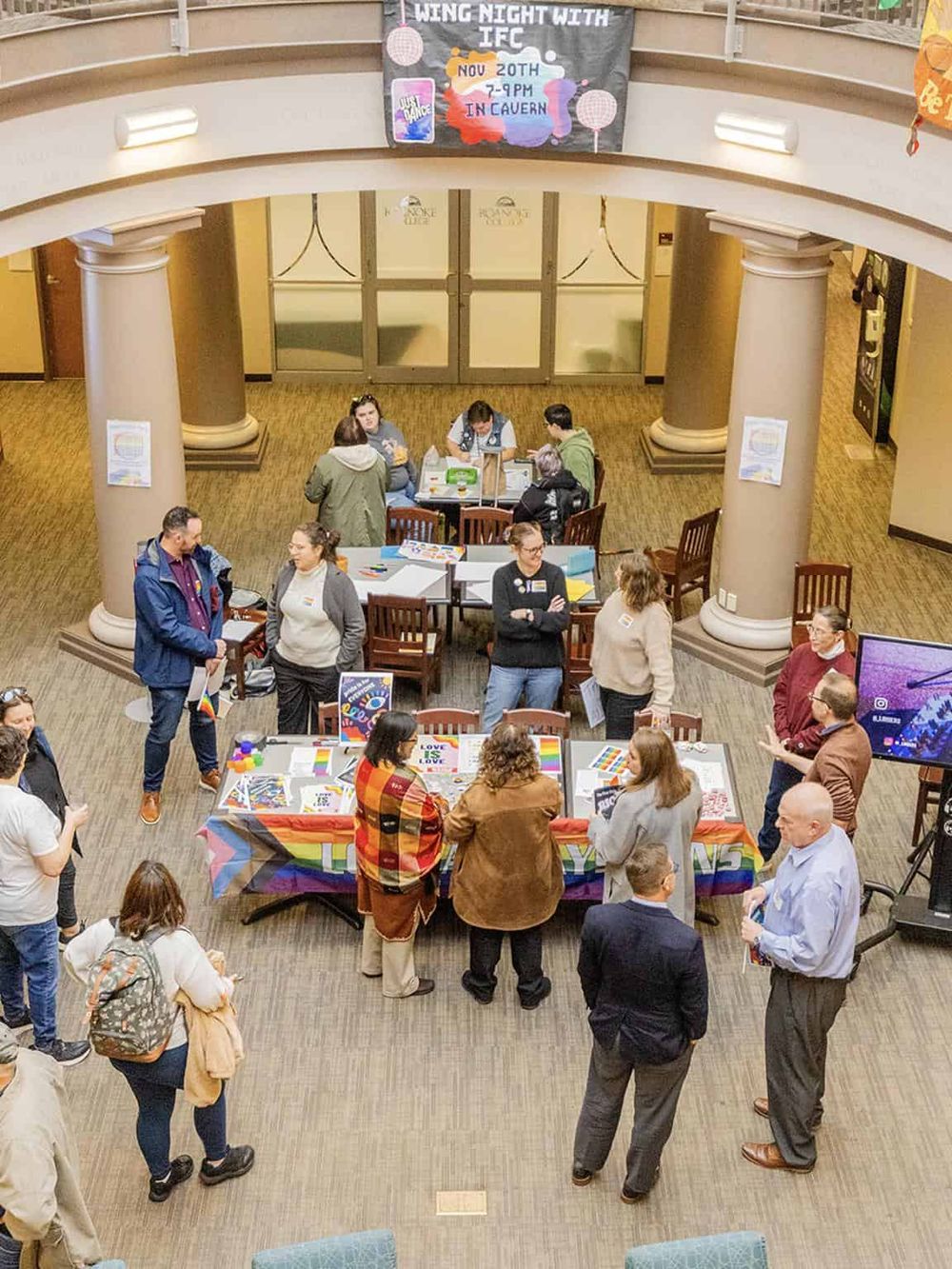 Busy community event promoting LGBTQ+ awareness and inclusivity at QuestForDirections.