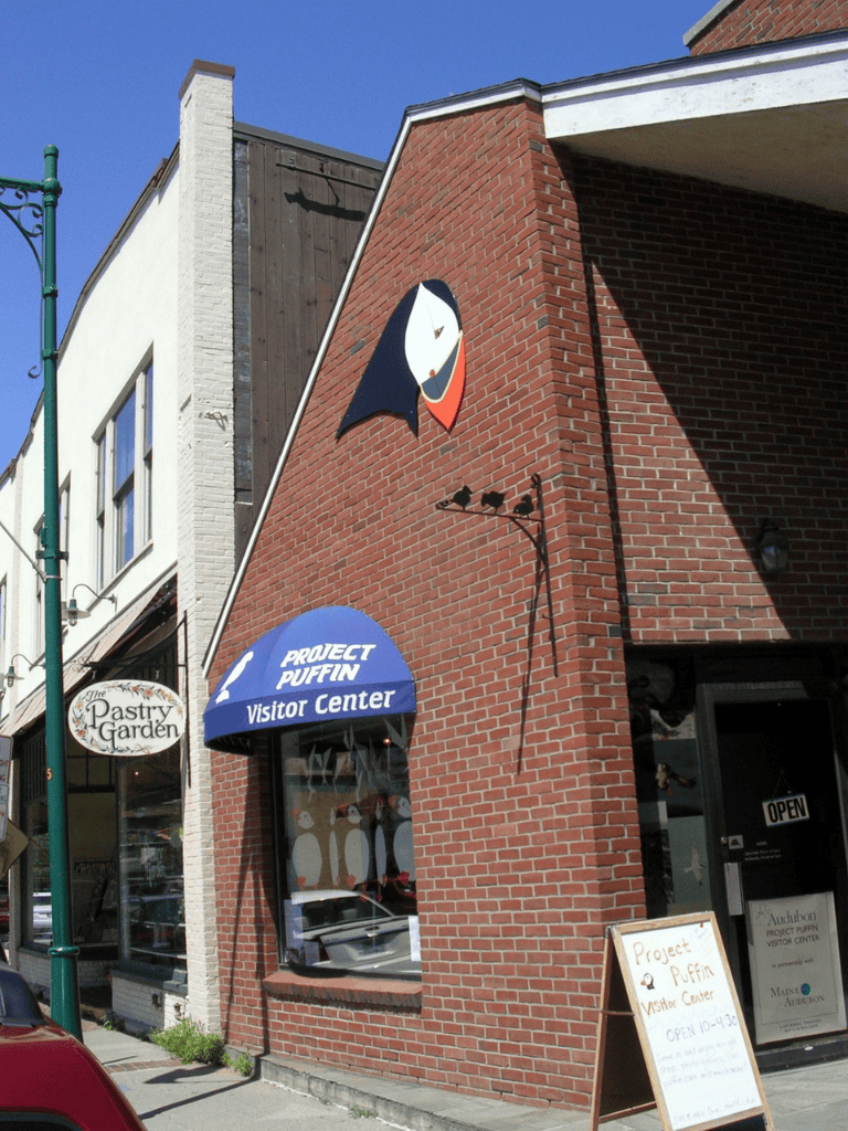 Cute puffin logo on building of Project Puffin Visitor Center, Main Audubon, in downtown.