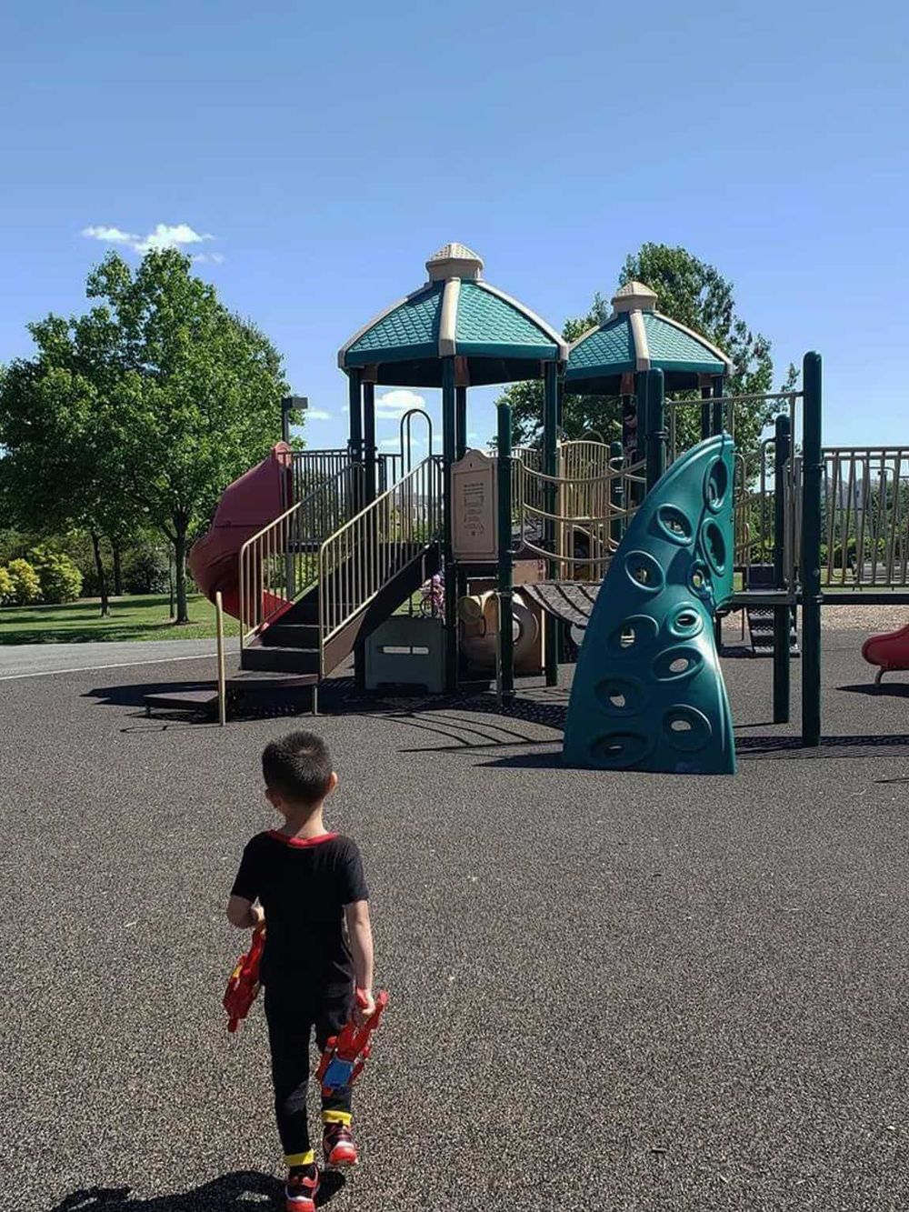 Colorful playground structure for children at park, outdoor activity, family fun, recreational area, kid-friendly playground equipment.