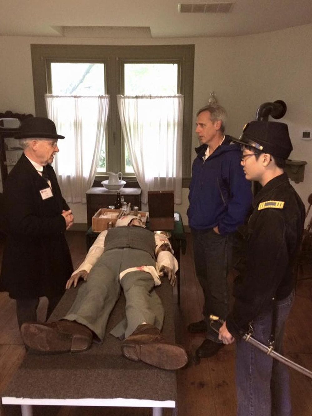 Realistic historical reenactment of a doctor performing a medical exam on a mannequin in a vintage setting.