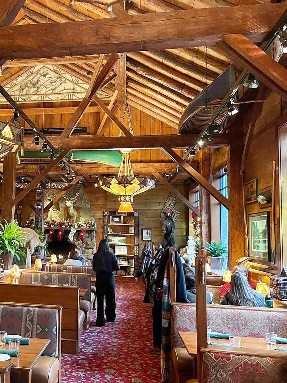 Cozy mountain lodge restaurant with rustic wood interior, hunting decor, and warm atmosphere.