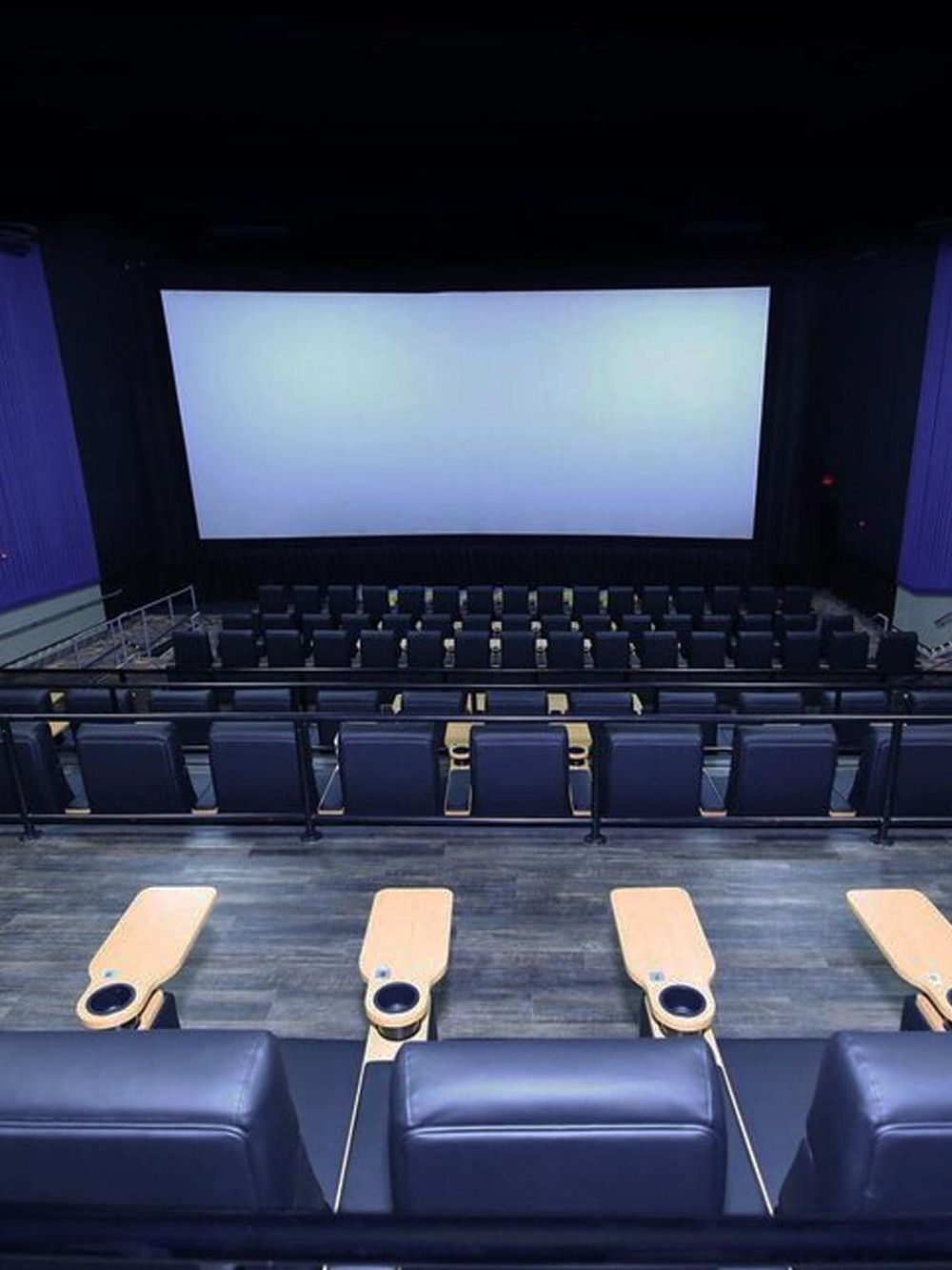 Modern movie theater interior with large screen and comfortable seating for immersive viewing experiences.