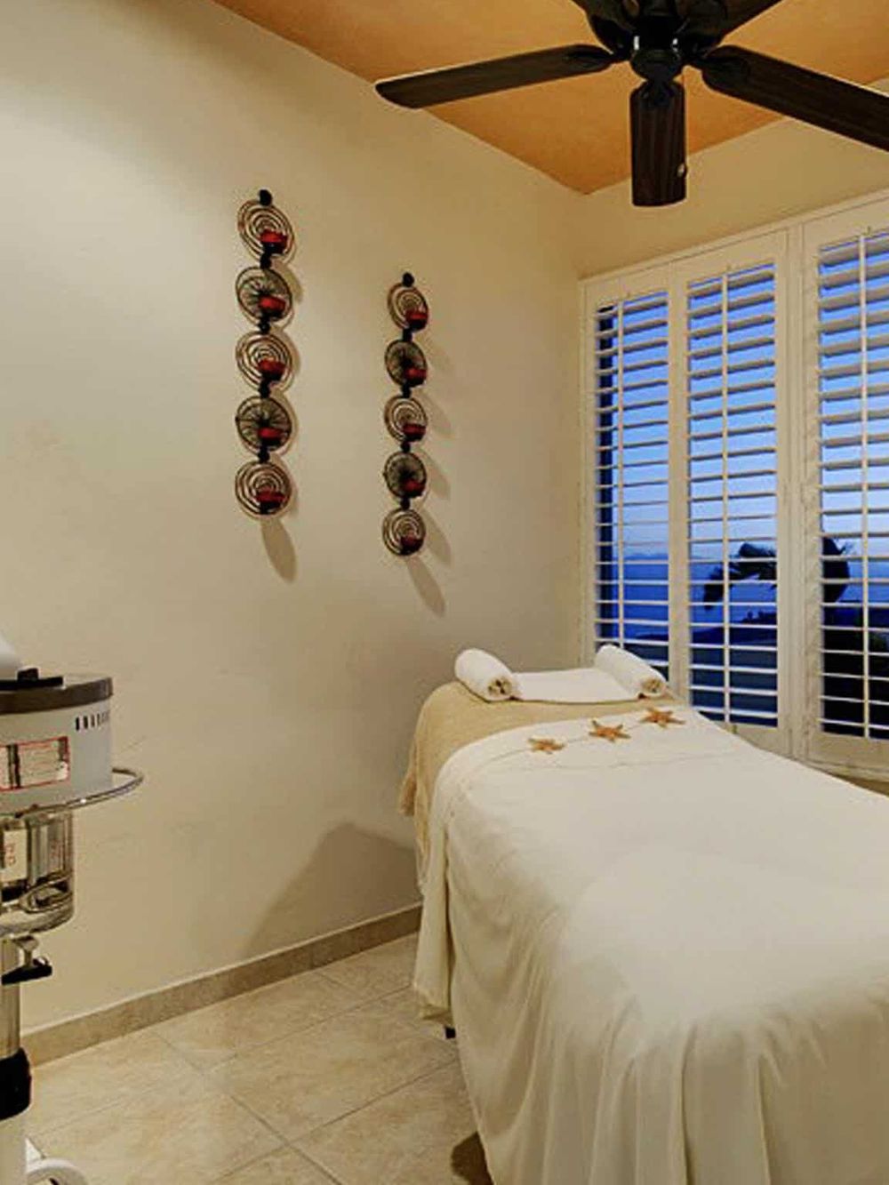 Relaxing massage room with comfortable treatment bed and calming decor, perfect for wellness and self-care.