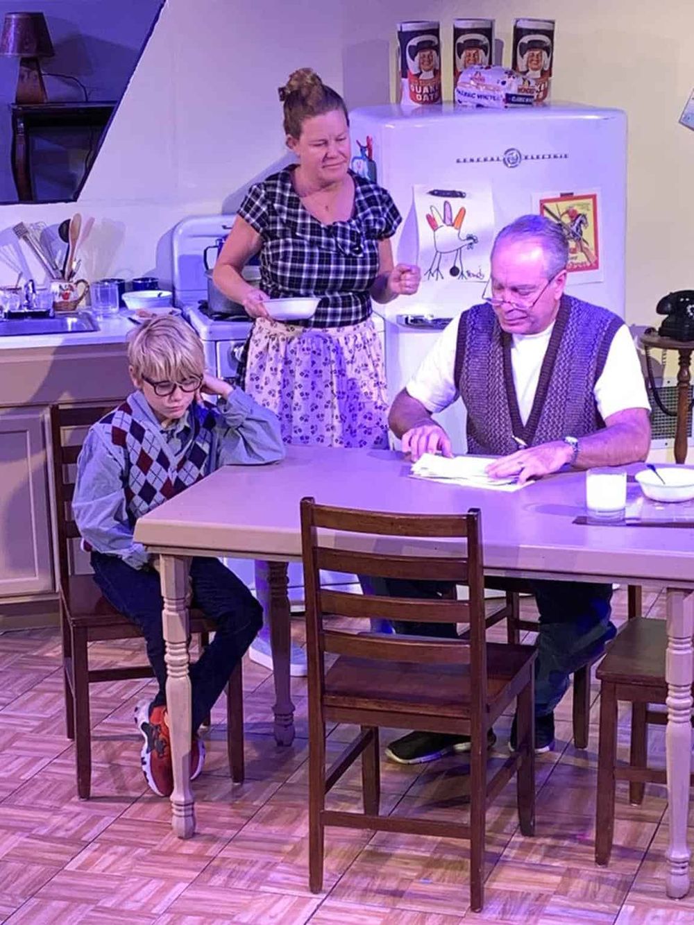 Aunt Jackie's breakfast scene with a woman and two children at a kitchen table.