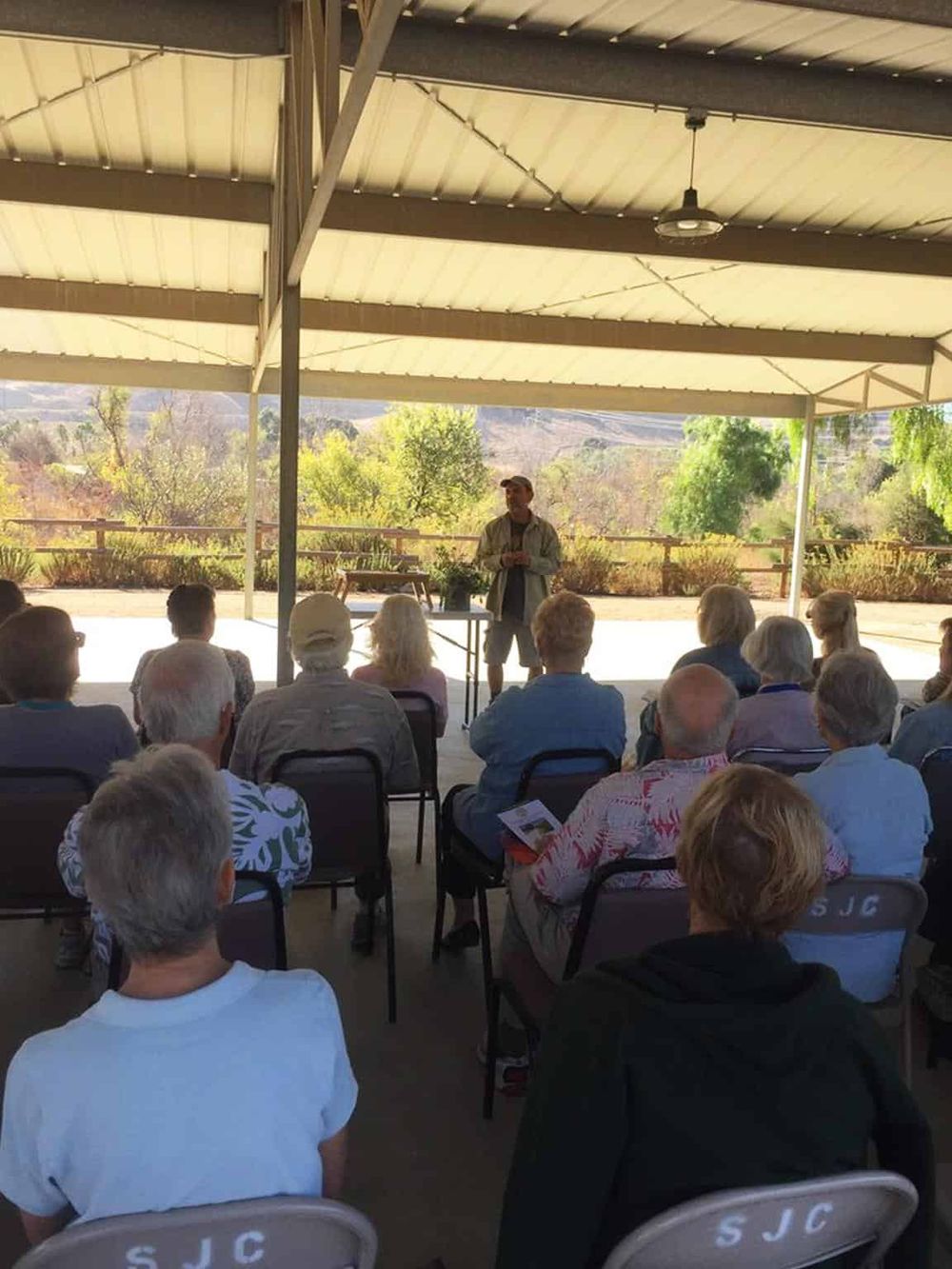 Outdoor community event showcasing an educational speaker at QuestForDirections.