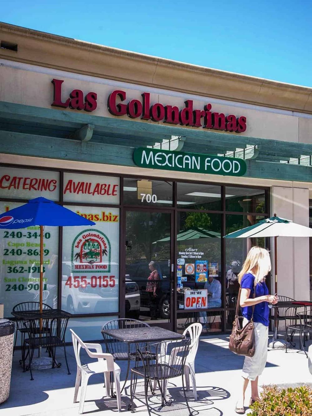 Authentic Mexican restaurant Las Golondrinas with outdoor seating and colorful signage.