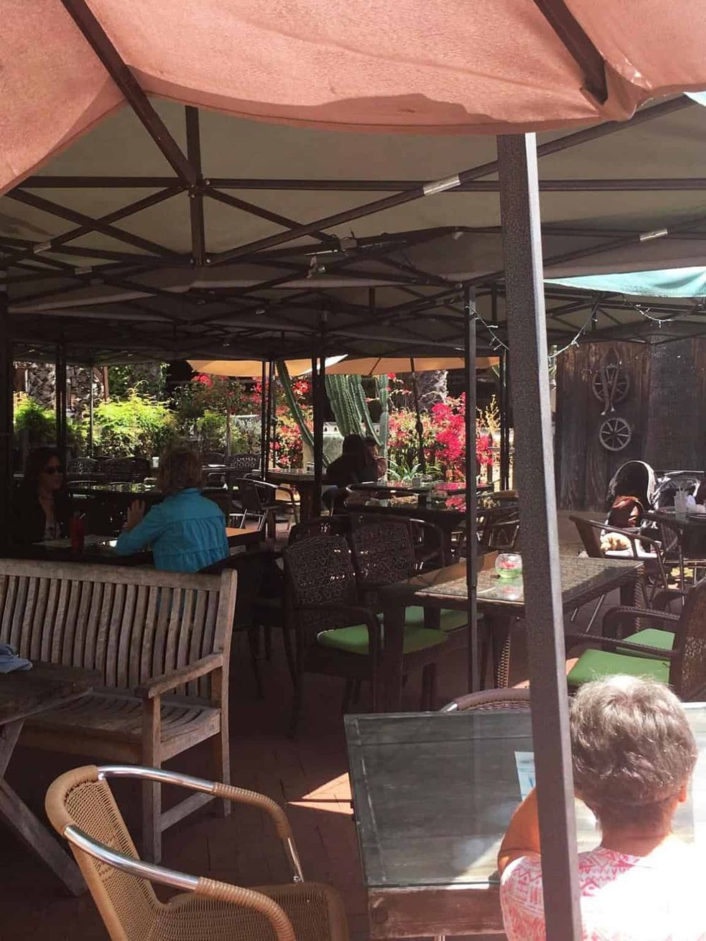 Alley outdoor dining area at QuestForDirections restaurant with seating under umbrellas.