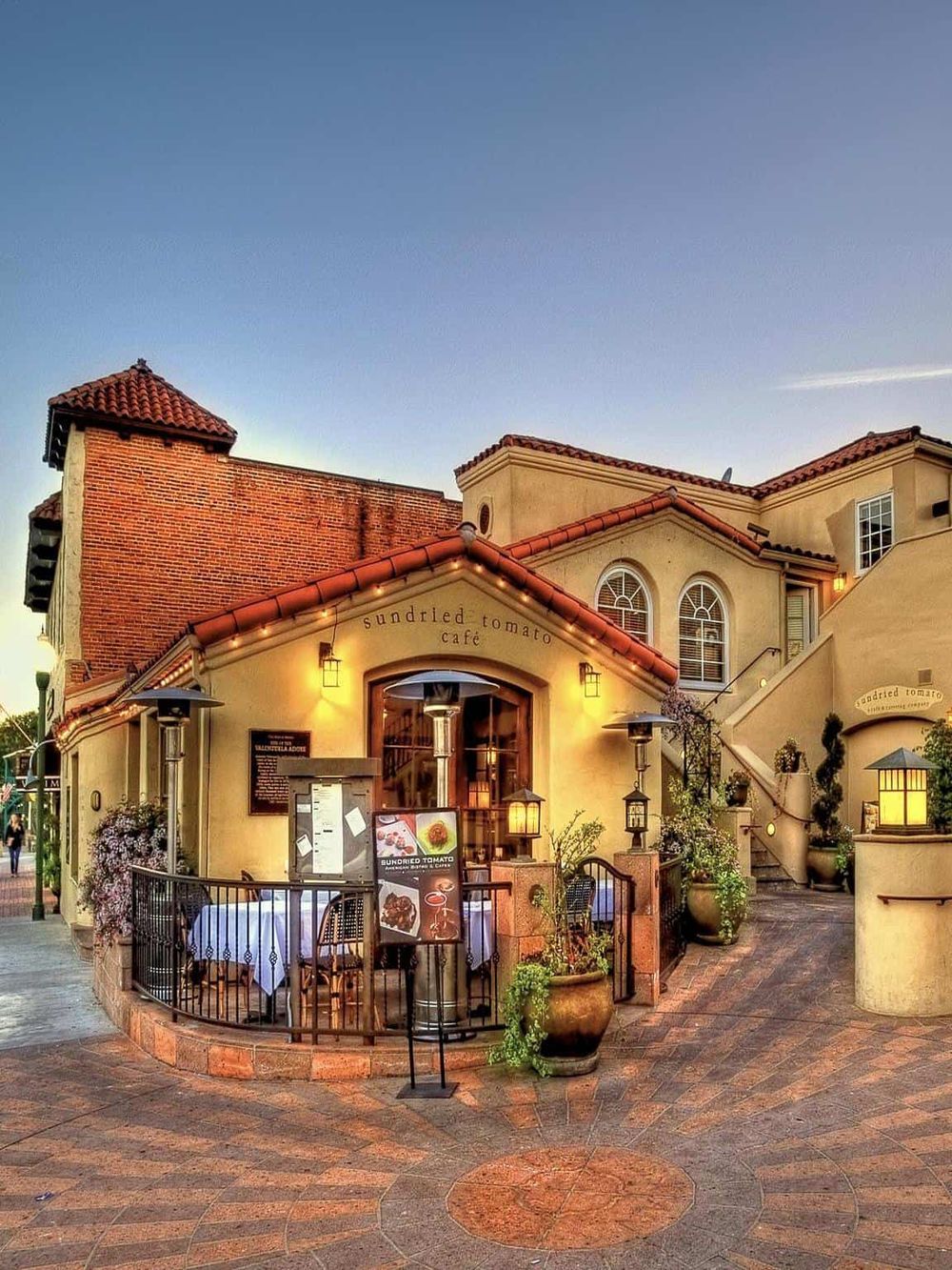 Charming Sunset Café at QuestForDirections shopping center with outdoor seating and cozy ambiance.