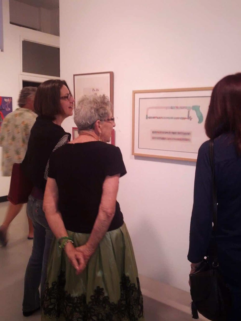 Intriguing abstract artwork viewing at QuestForDirections art gallery event, showcasing modern art and engaging visitors.