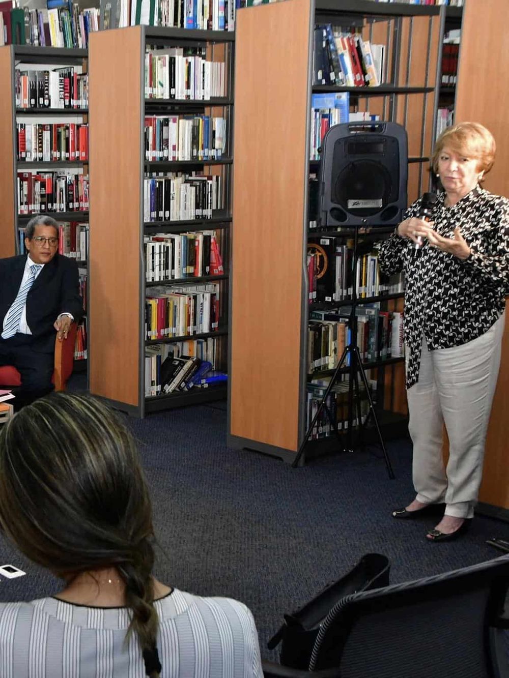 Accessible library space with speakers discussing community programs and resources.