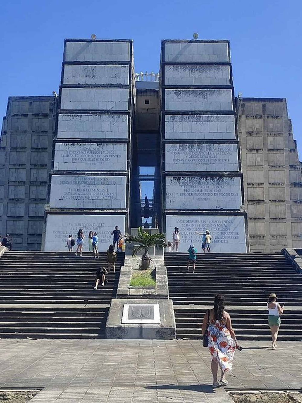 Ancient Mayan pyramid in Mexico, popular tourist landmark, steep stairs, and visitors exploring historical site.