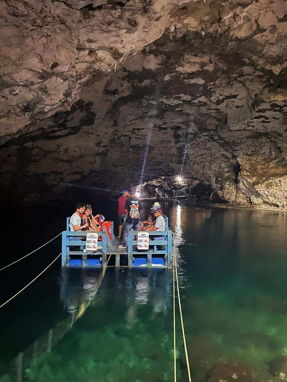 Underground cave boat tour exploring natural rock formations and crystal-clear water.