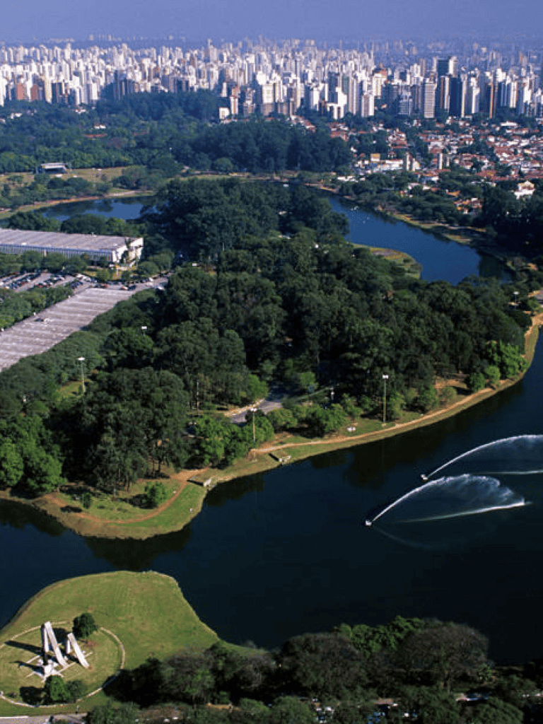 Aerial view of Ibirapuera Park with city skyline in São Paulo, Brazil.