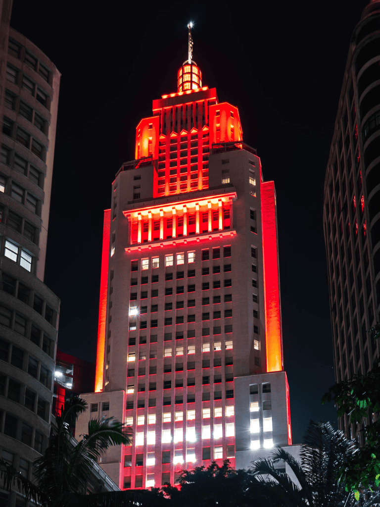 Brightly lit Empire State Building at night, showcasing iconic NYC skyline and illuminated architectural design.