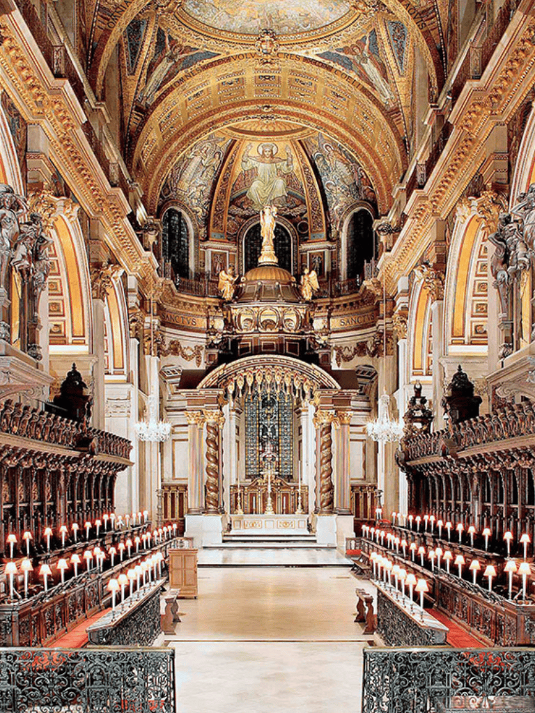 Luxurious church interior with ornate gold accents and religious statues.