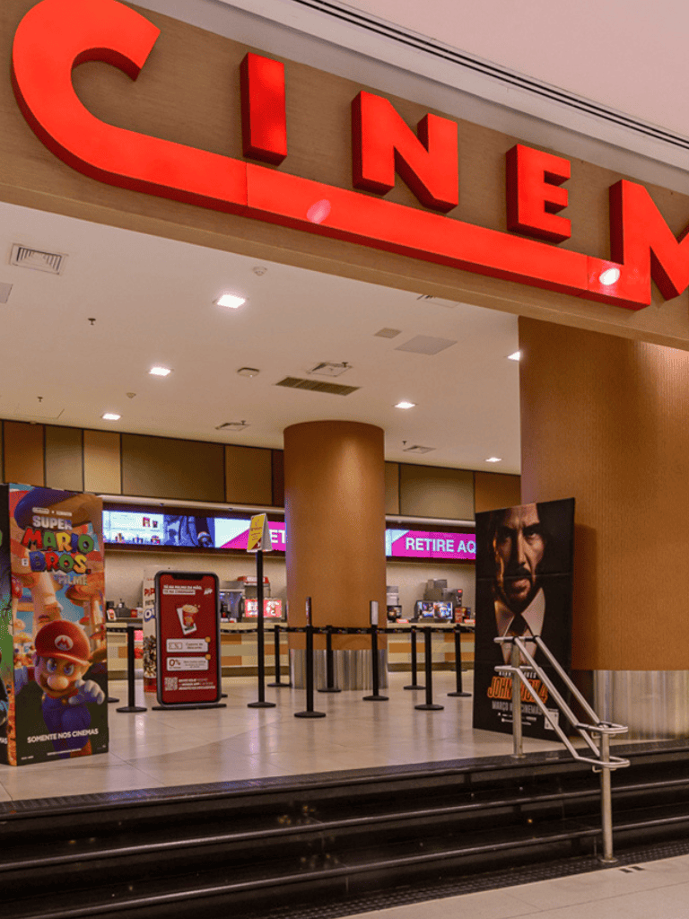 Cinemas at shopping mall with movie posters and ticket counters for easy movie theater access.