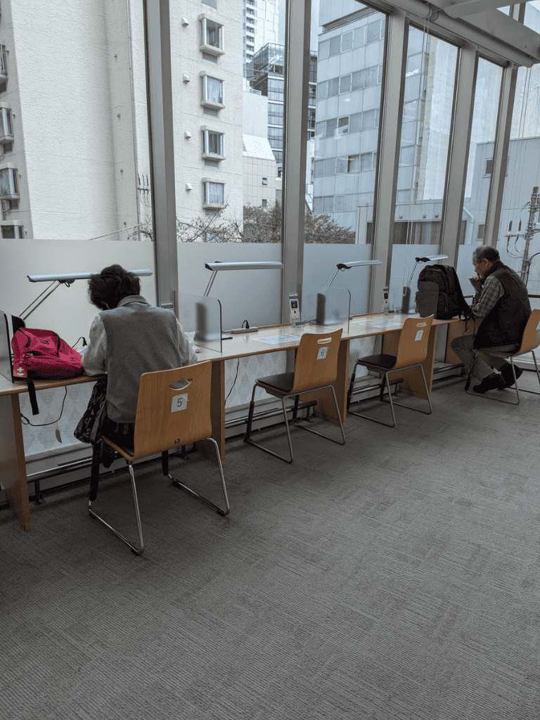Open study pods in modern coworking space with city view.