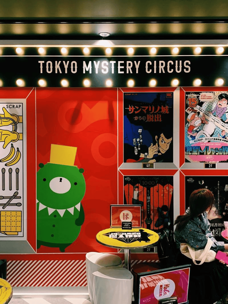 Cute cartoon bear with top hat at Tokyo Mystery Circus, vibrant arcade entertainment in Japan.
