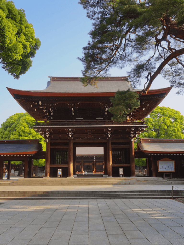 Ancient Japanese temple surrounded by lush trees, traditional architecture, serene cultural landmark.