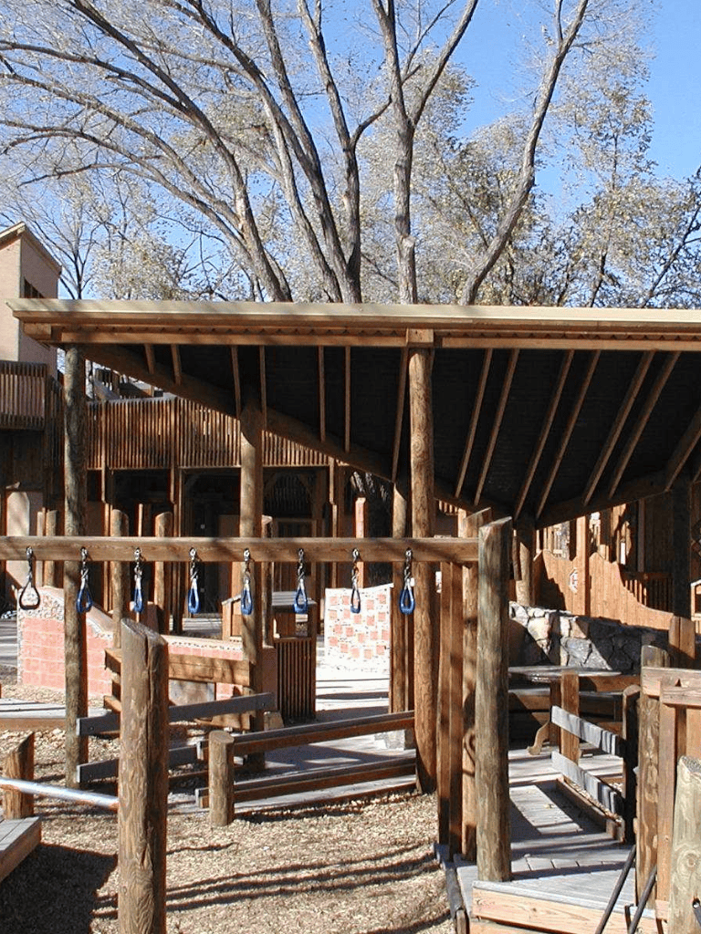 Wooden playground equipment at QuestForDirections outdoor activity area, suitable for kids' adventures.