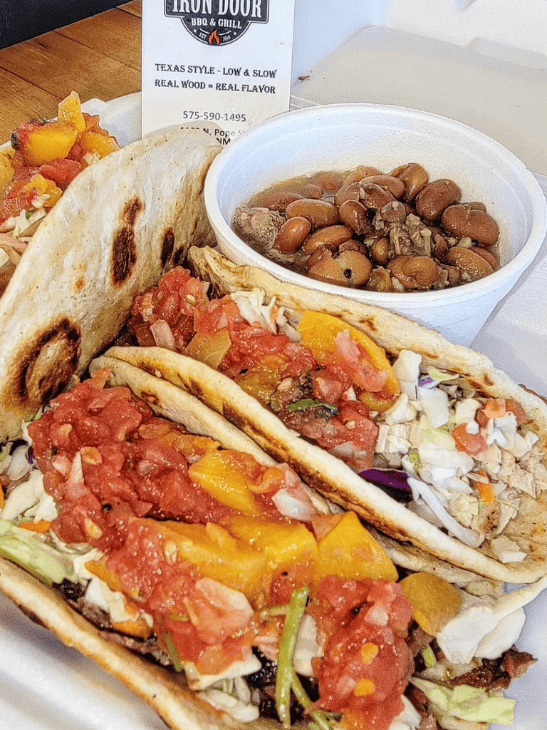Savory tacos with beans and fresh vegetables from QuestForDirections restaurant, Texas-style BBQ and grill.